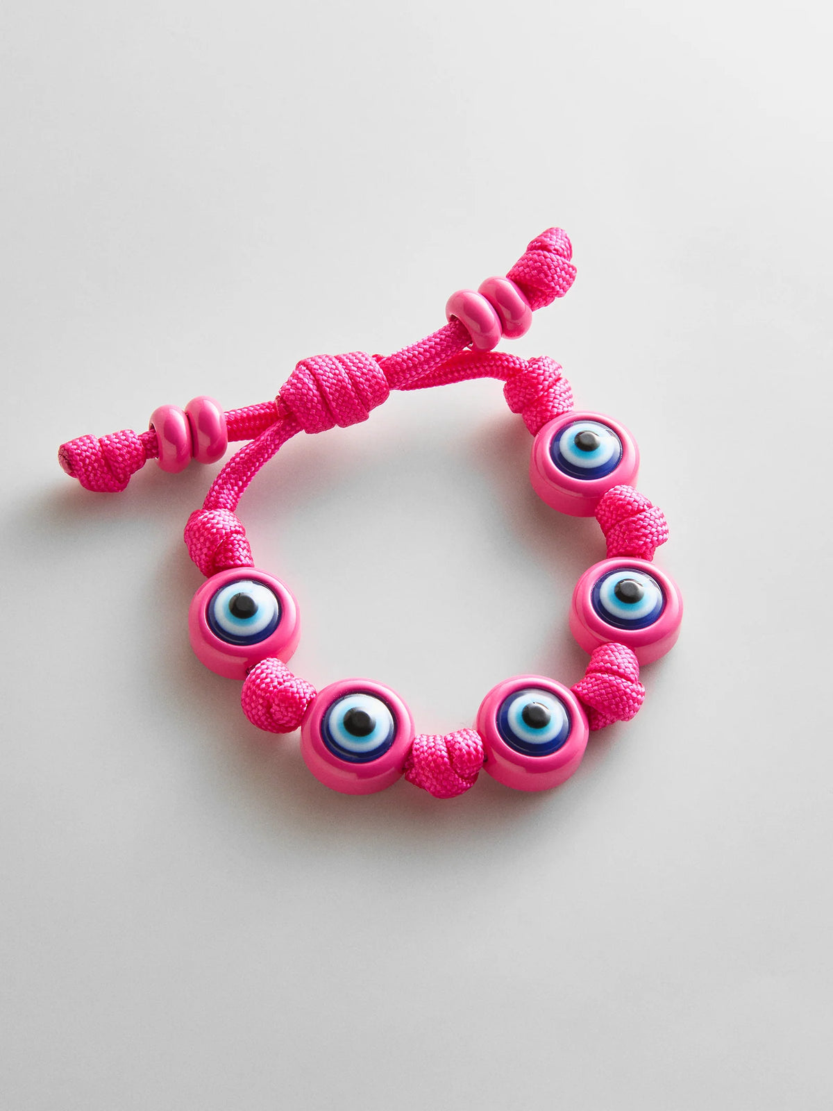 KNOTTY GOOD EYE CORD BRACELET  FUSHCIA