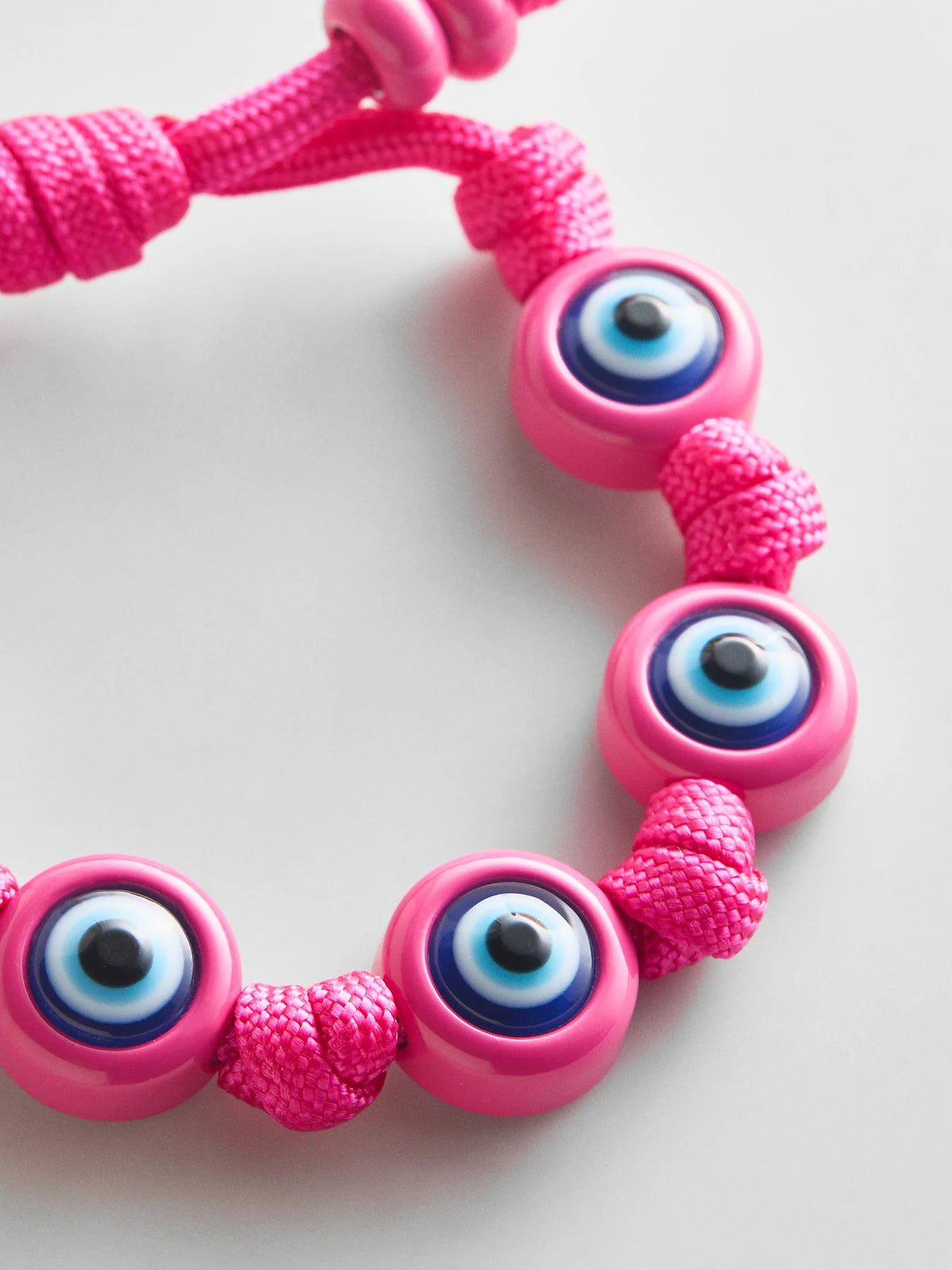 KNOTTY GOOD EYE CORD BRACELET  FUSHCIA