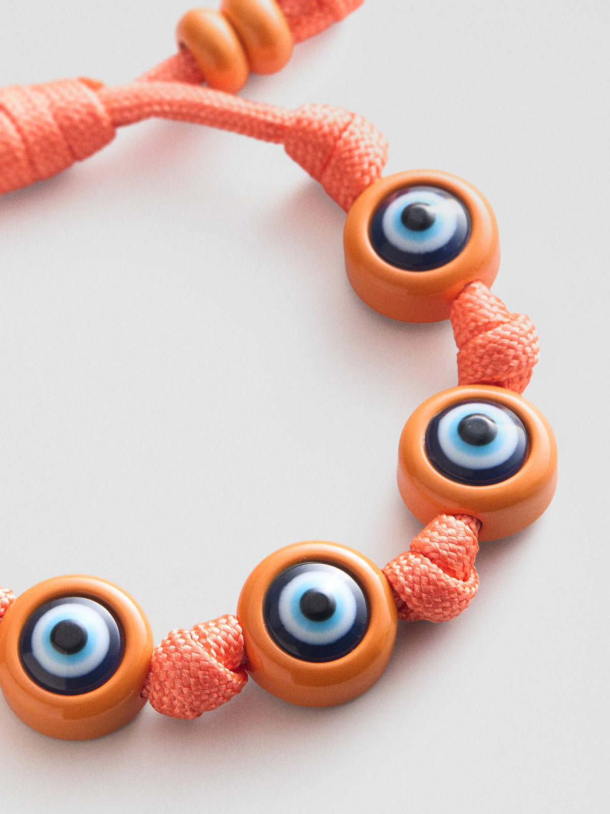 KNOTTY GOOD EYE CORD BRACELET  TANGERINE
